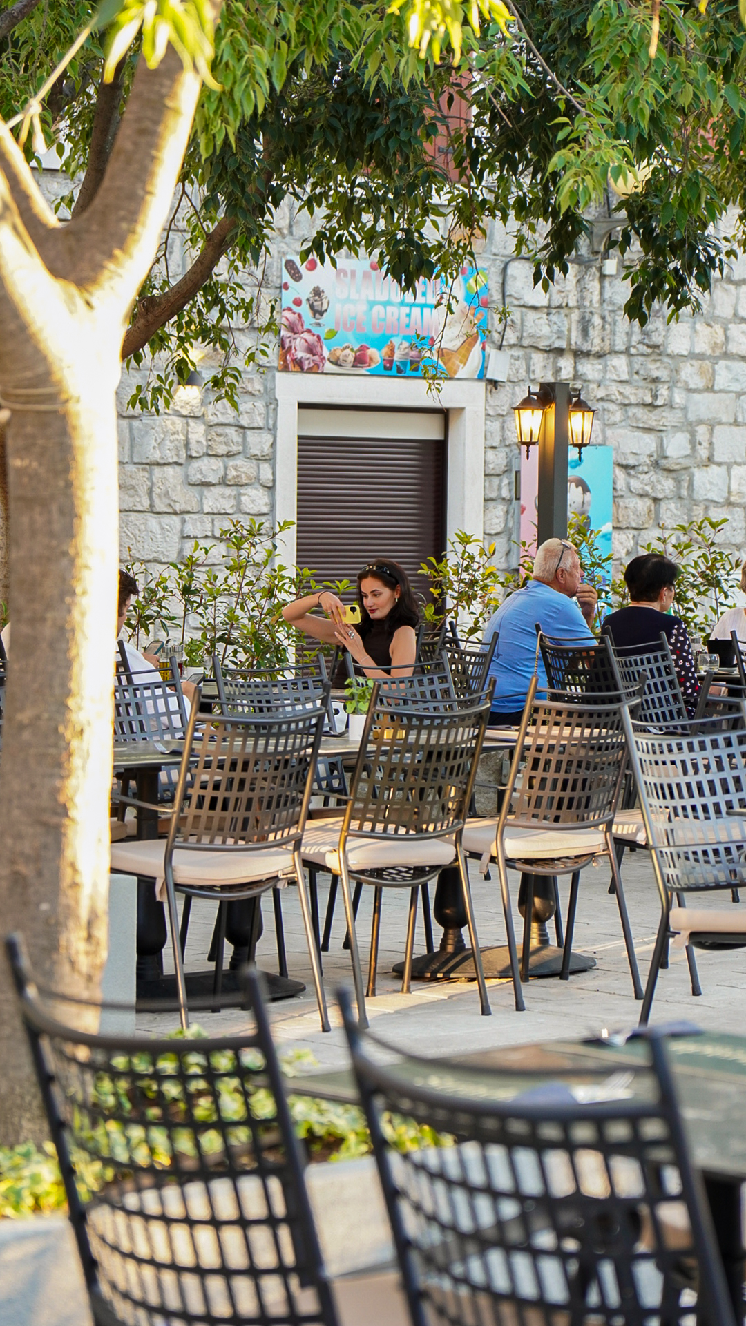 Guests seated on Strada's stone-walled terrace